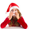 Christmas Santa kid girl blowing her nose in a winter cold isolated on white background