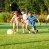 Four preschool kids playing with the ball